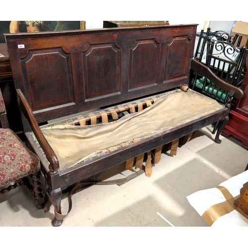 989 - A 19th Century oak settle with four panelled back, length 185cm (seat a/f).