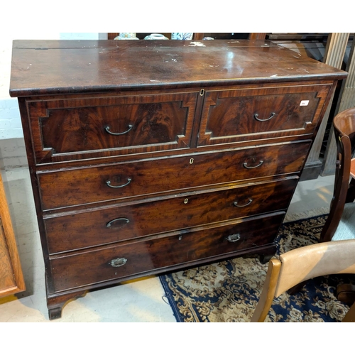 994 - A Georgian mahogany chest with hinged top section and three long drawers below with panelled drawers... 