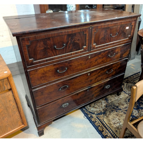 994 - A Georgian mahogany chest with hinged top section and three long drawers below with panelled drawers... 