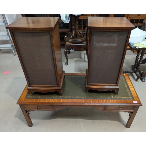 1040 - A reproduction mahogany coffee table with drawers and leather top, and a pair of Reprodux speaker ca... 