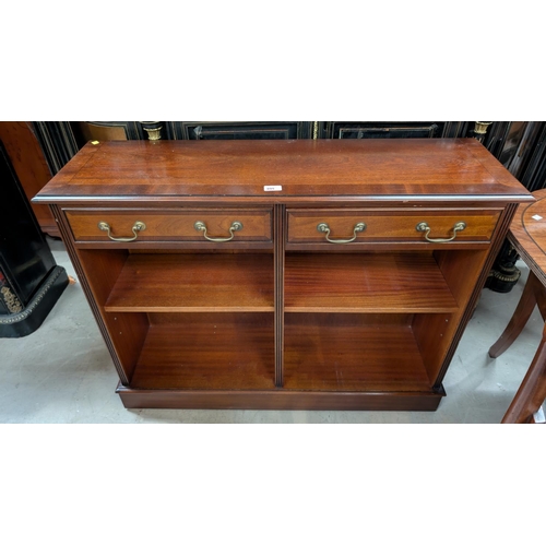 895 - A reproduction mahogany bookcase with drawers above.