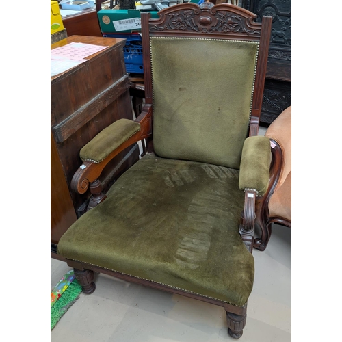 956 - An Edwardian mahogany armchair with carved crest and turned legs in studded olive green velvet.