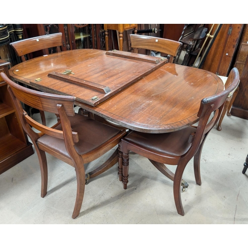 975 - A early/mid 20th Century Regency style 'D' end extending twin pedestal dining table and a set of fou... 