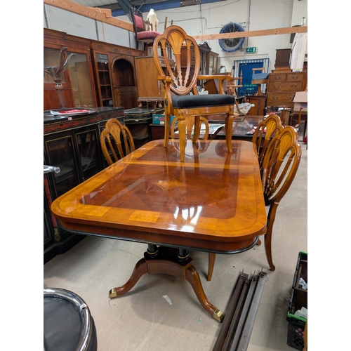 1045 - A large classical style extending dining table and chairs with sunburst inlay pierced back, high glo... 