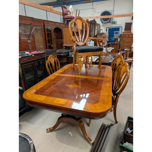 1045 - A large classical style extending dining table and chairs with sunburst inlay pierced back, high glo... 