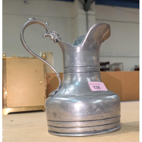 138 - A 19th Century pewter jug with stamps to base and dragon on handle, height 20cm.