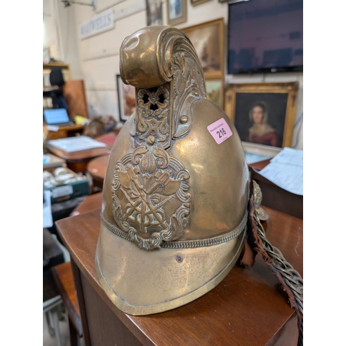 216 - A Victorian brass fireman's helmet with leather interior and strap.