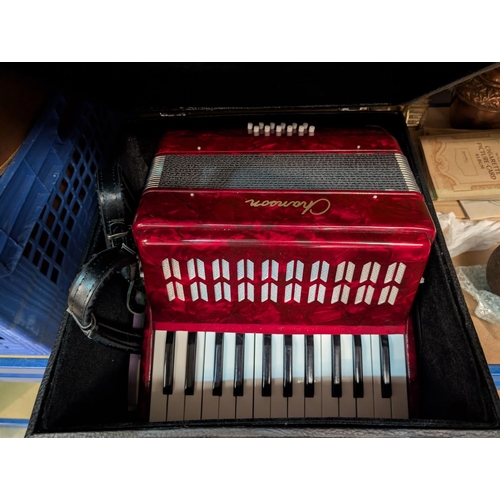 32 - A cased 12 button piano accordion (travel size)