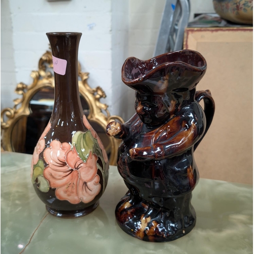 550A - A Moorcroft hibiscus vase with brown glaze and a treacle glazed Toby jug.