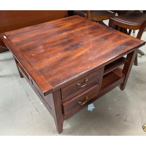 943A - A large square coffee table with drawers bellow