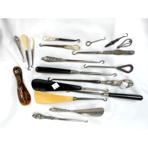 729 - A collection of button hooks, shoe horns etc, some with silver handles.