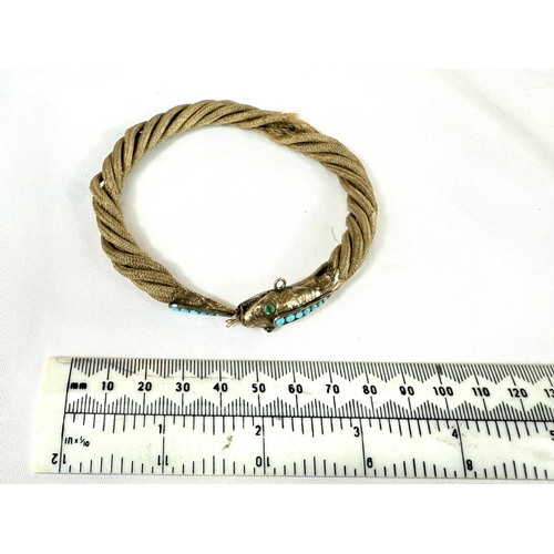 741 - A Victorian rope twist hair bracelet with yellow metal clasp in the form of a fish inset with turquo... 