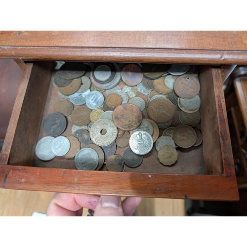 220 - A coin collection in four drawer mahogany collecting cabinet.