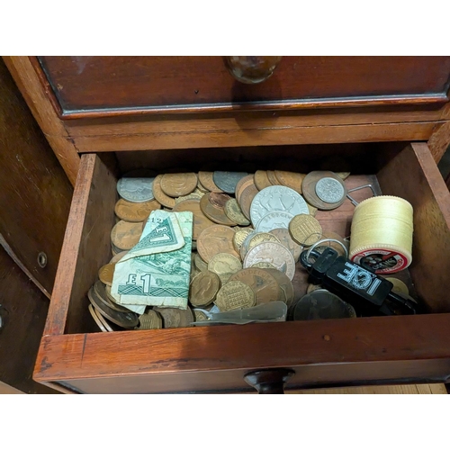 220 - A coin collection in four drawer mahogany collecting cabinet.