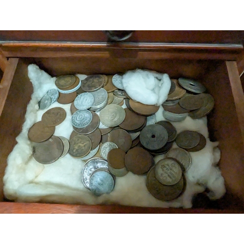 220 - A coin collection in four drawer mahogany collecting cabinet.