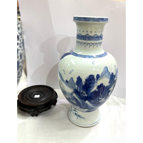 420A - A Chinese blue and white bulbous vase with mountainous scenes and geometric designs height 36cm with... 