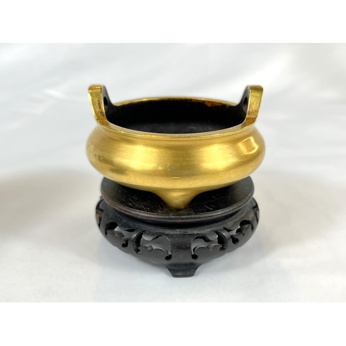 420B - A Chinese gilt bronze censer on fitted wooden stand, 6 character impressed seal mark to base, 2 hoop... 