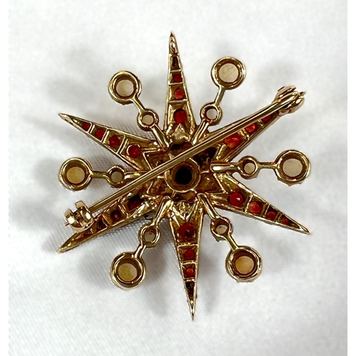 798A - A Victorian star brooch set with alternating rows of seed pearls and graduating garnets (unmarked).