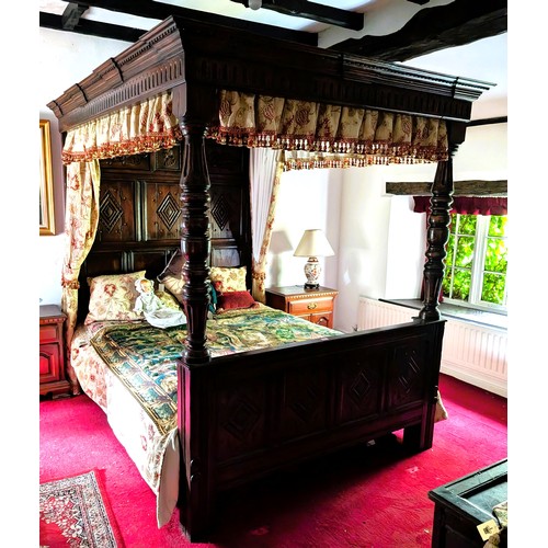 918 - An oak four poster bed with solid canopy above, carved detail to foot and head, with turned supports... 