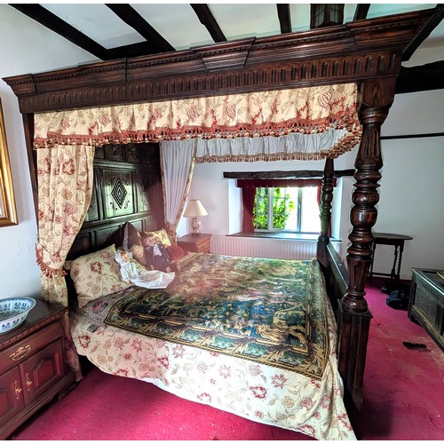 918 - An oak four poster bed with solid canopy above, carved detail to foot and head, with turned supports... 