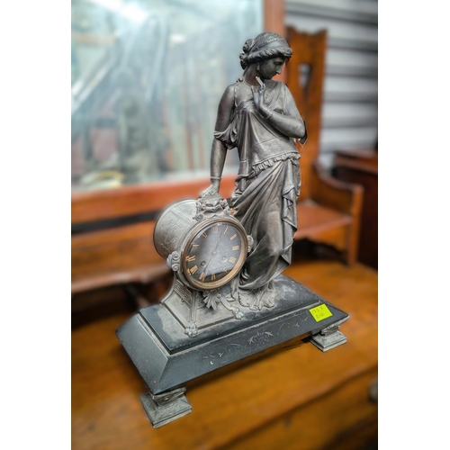 185 - A late 19th/early 20th century clock with female Spelter figure on marble plinth.