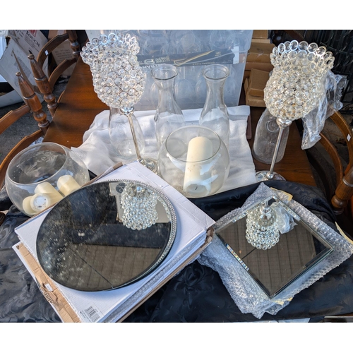 24 - A collection of modern table centres, wine carafes and modern wine glasses.