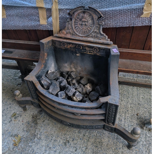 29 - A traditional cast iron fireplace.