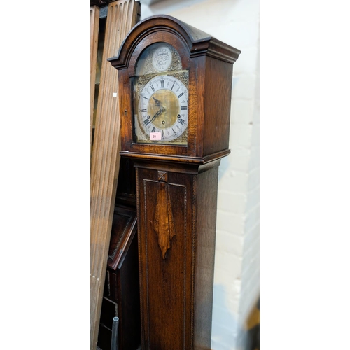 60 - A 1930's oak cased granddaughter clock, Tempis Faucets brass faced dial.