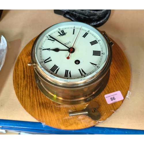 86 - A Smith Astral brass cased ships clock on wooden boat.