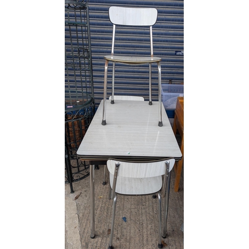 950 - A 1960's chrome and white wood effect breakfast table and 4 chairs by TAVO, Belgium.