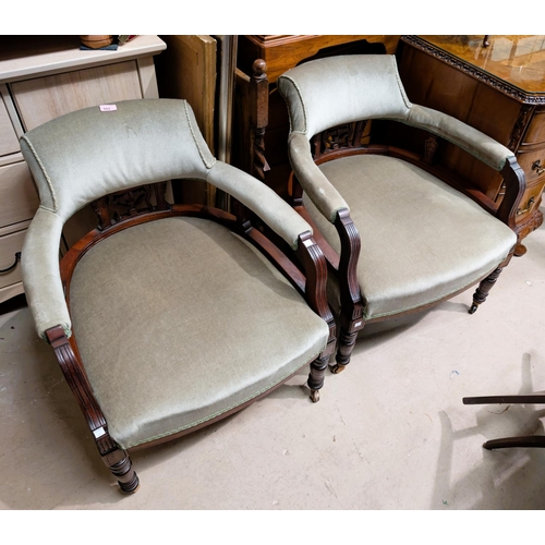 982 - A pair of late 19th Century/early 20th Century mahogany tub chairs with pierced galley back in a sag... 