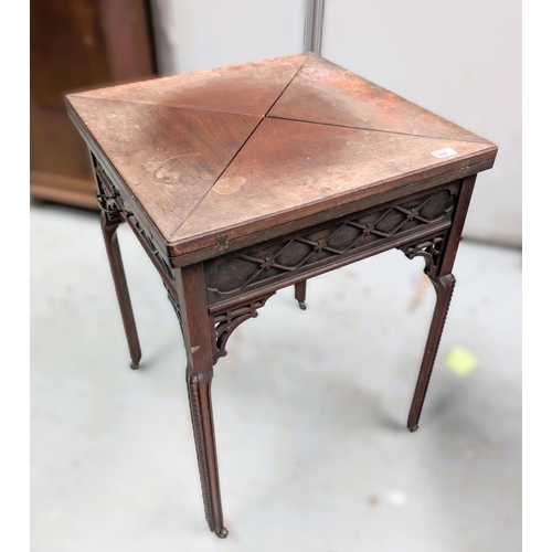 1041 - A Waring and Gillows envelope card table with various fretwork etc.