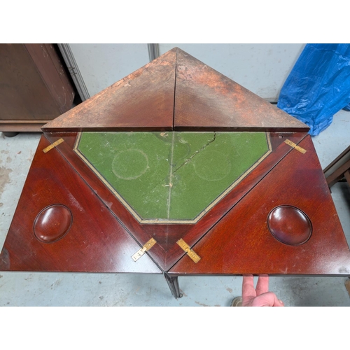 1041 - A Waring and Gillows envelope card table with various fretwork etc.