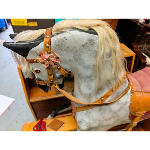 326 - A Victorian style rocking horse, dapple grey with real hair mane and tail, leather reins, stirrups e... 