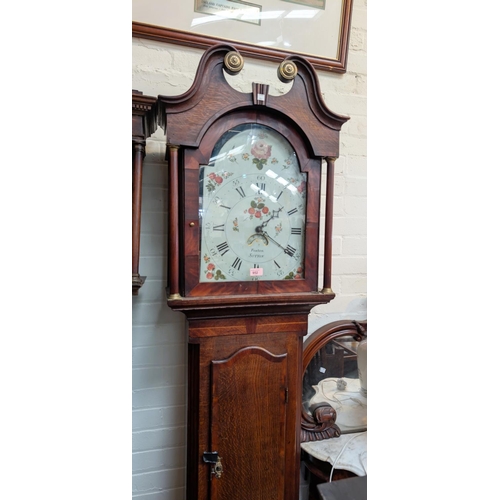 952 - An early 19th Century oak longcase clock with mahogany cross banding, the hood, with swan neck pedim... 