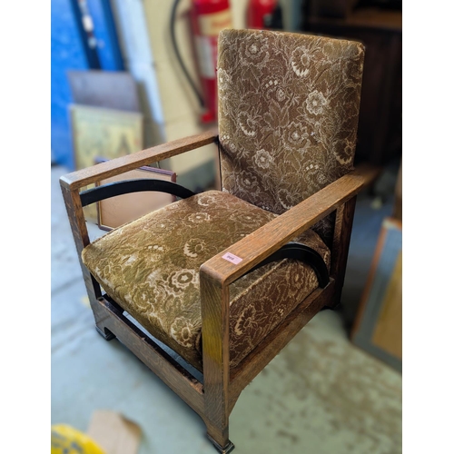 966 - An oak framed Art Deco low seat armchair in brown moquette.