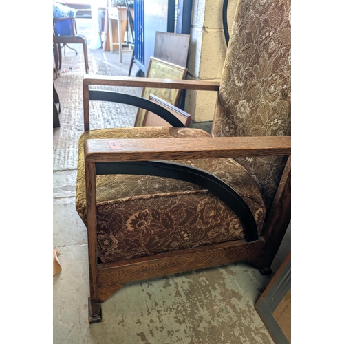 966 - An oak framed Art Deco low seat armchair in brown moquette.