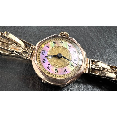 656 - A lady's vintage wristwatch with 9ct gold case and strap - gross weight 23gm.