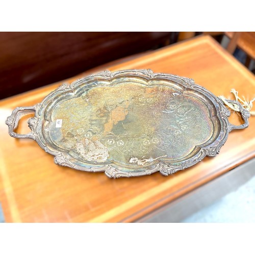 737 - A large oval two handled silver on copper tray with relief acanthus decoration and chased floral cen... 