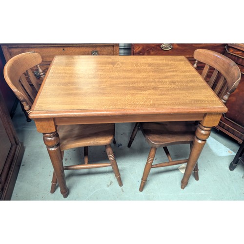 908 - A small oak kitchen table with lath back chairs.