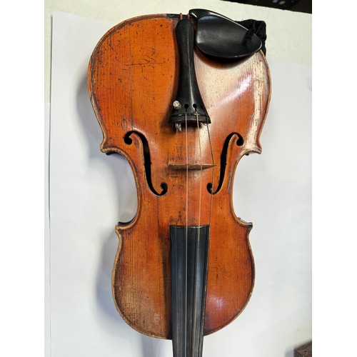 386 - An early 20th century violin with two piece back, interior label, body length 37.5cm, incised decora... 