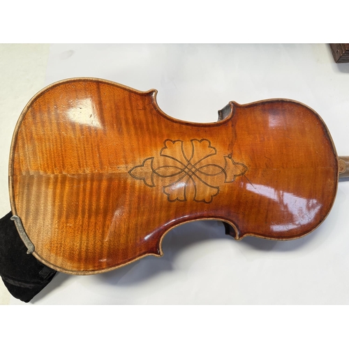 386 - An early 20th century violin with two piece back, interior label, body length 37.5cm, incised decora... 