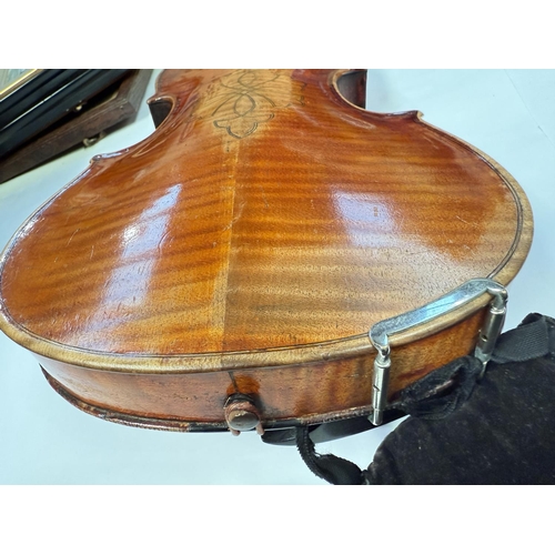 386 - An early 20th century violin with two piece back, interior label, body length 37.5cm, incised decora... 