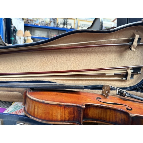 386 - An early 20th century violin with two piece back, interior label, body length 37.5cm, incised decora... 