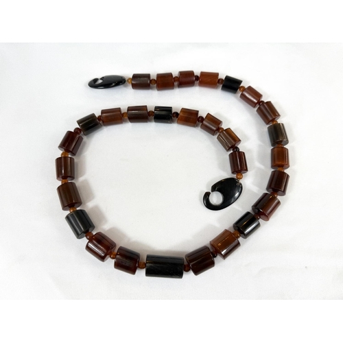 739B - An amber necklace formed from cylindrical beads, length 75cm, 13gms.