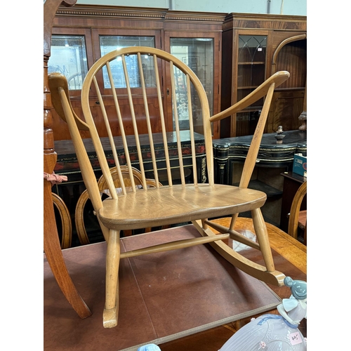 995 - An Ercol light wood rocking chair, stick back;