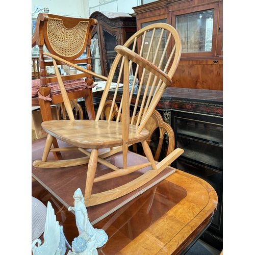 995 - An Ercol light wood rocking chair, stick back;