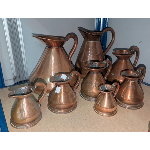 2 - 8 graduating copper jugs from 1/4 gill upwards.