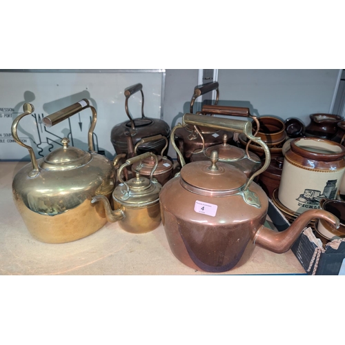 4 - A collection of copper teapots, varying sizes and two brass tea pots..