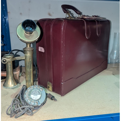 8 - A leather Dumple carry bag; two vintage money boxes and a stick telephone.